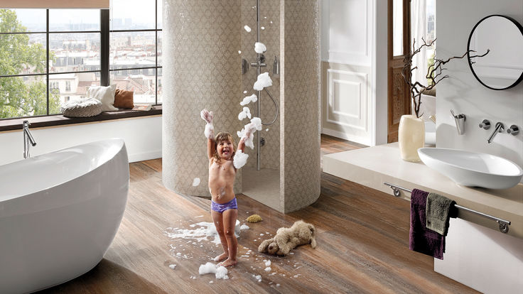 Kind spielt mit Schaum vor der Dusche